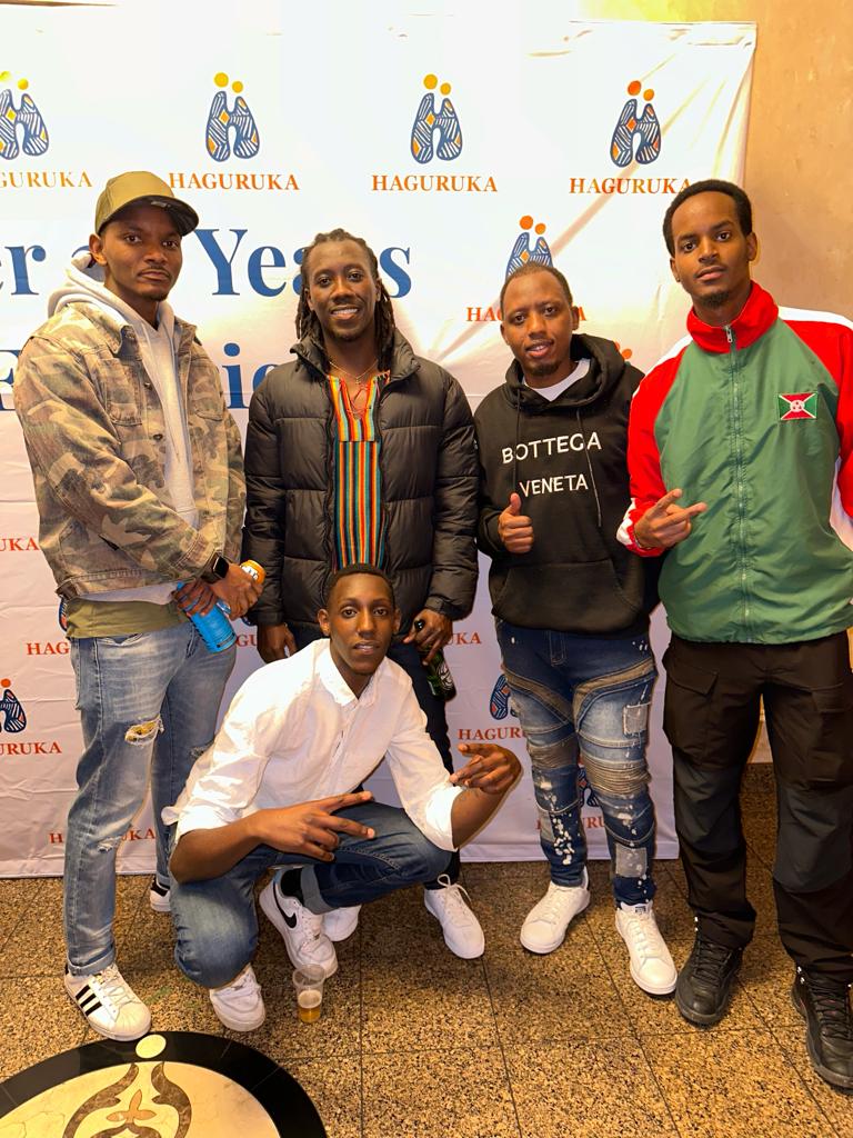 Members of the group together offstage at a community celebration