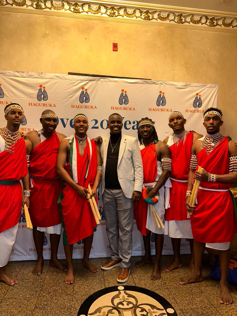 Members of the ensemble standing together holding drumsticks at an event